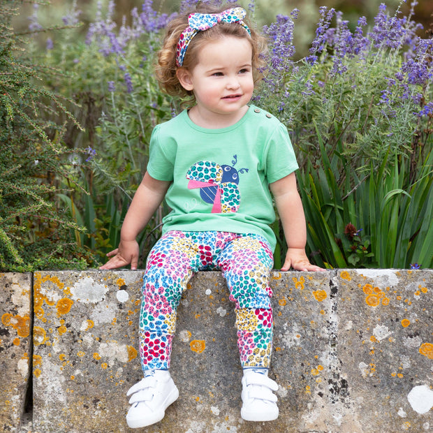 Girl in ladybird ditsy leggings