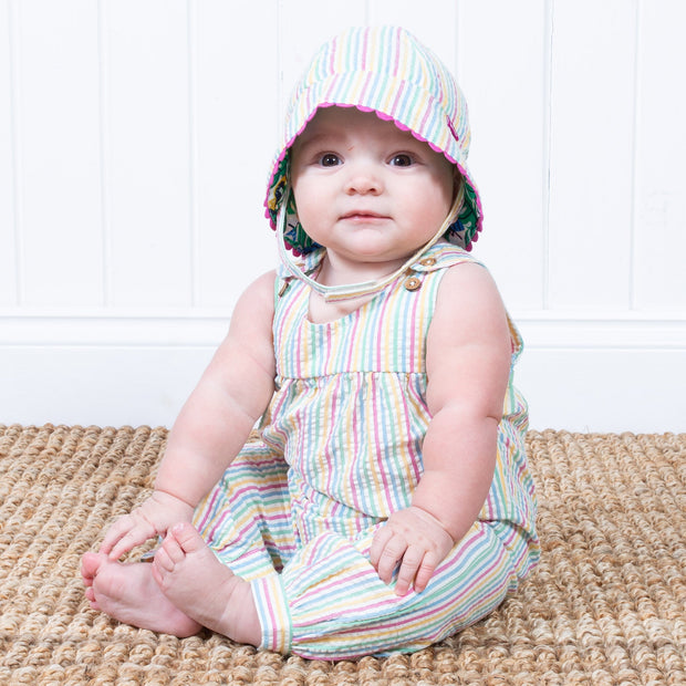 Baby girl in seersucker dungarees