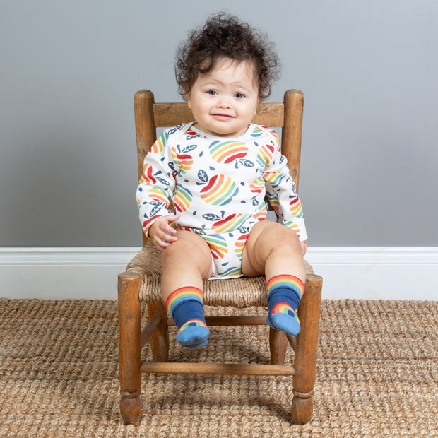 Baby in apple bodysuits