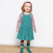 Girl in speckle pinafore