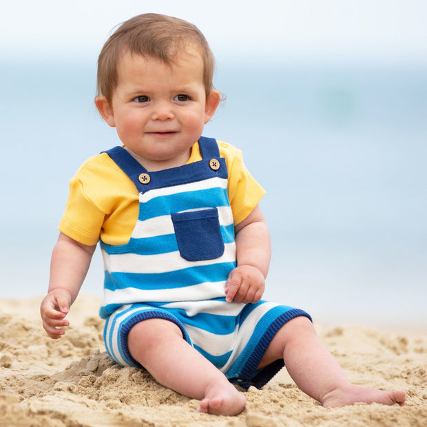 Baby in stripy knit dungarees