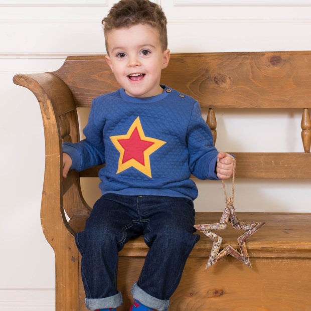 Boy in quilted star sweatshirt