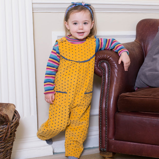 Girl in rainbow stripe jumper