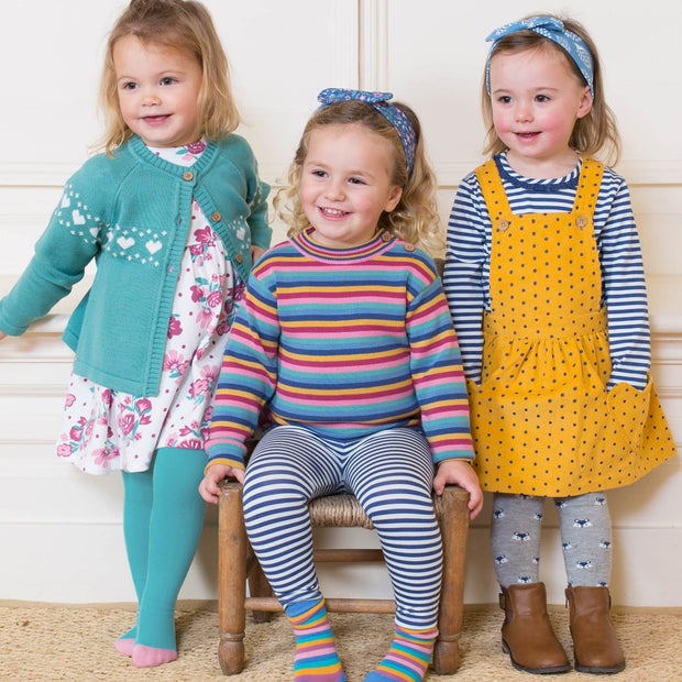 Girl in rainbow stripe jumper