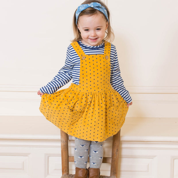 Girl in polka heart pinafore