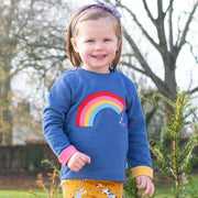 Girl in rainbow sweatshirt