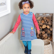 Girl in birdy pinafore